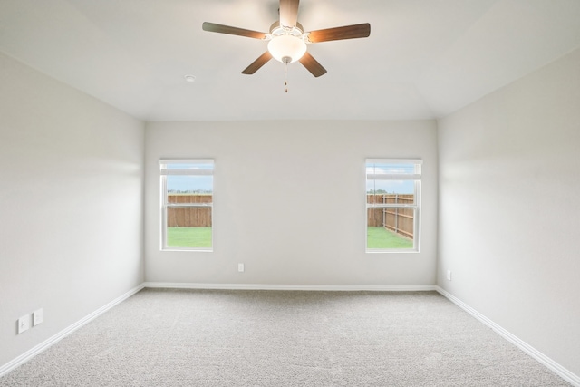 unfurnished room featuring ceiling fan, a healthy amount of sunlight, and carpet floors