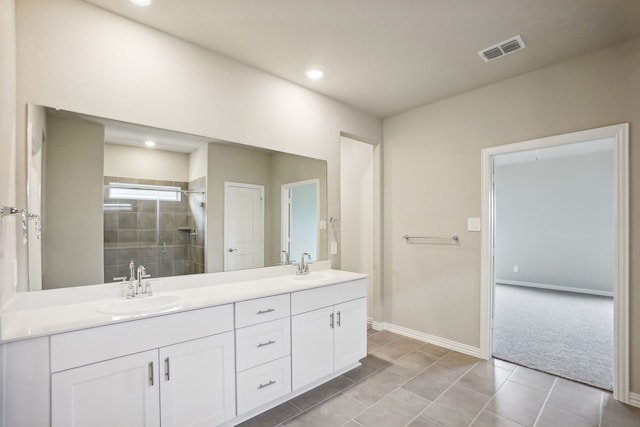 bathroom with tile patterned flooring, vanity, and walk in shower