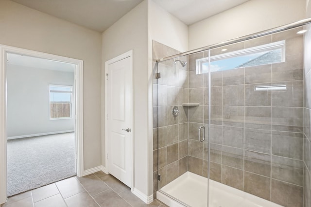 bathroom with tile patterned flooring and a shower with shower door