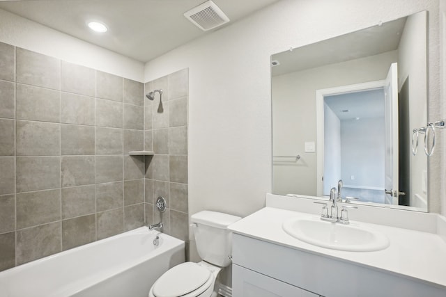 full bathroom featuring vanity, toilet, and tiled shower / bath