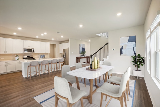 dining room featuring a wealth of natural light, dark wood-type flooring, and sink