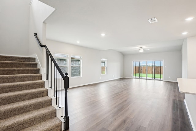 unfurnished living room with ceiling fan, a healthy amount of sunlight, and hardwood / wood-style flooring