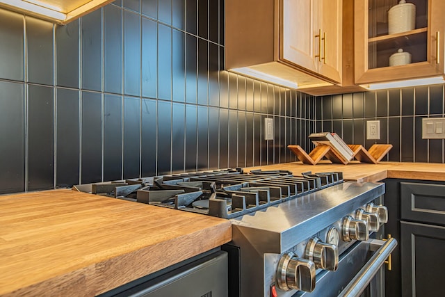 kitchen featuring tasteful backsplash and high end stove