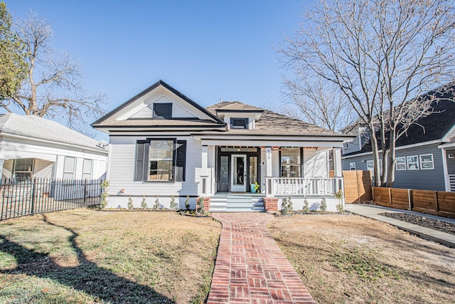 view of front of property with a porch and a front yard