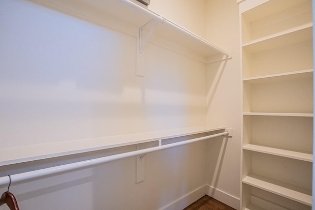 spacious closet with dark hardwood / wood-style floors