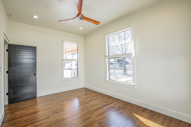 spare room featuring dark hardwood / wood-style floors and ceiling fan