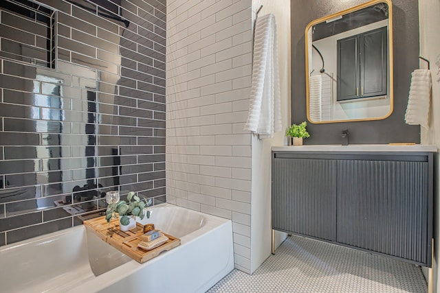 bathroom with vanity, tile patterned flooring, and a washtub