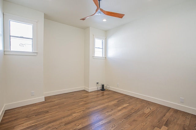 spare room featuring ceiling fan and dark hardwood / wood-style flooring