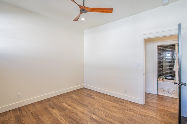 unfurnished room with ceiling fan and wood-type flooring