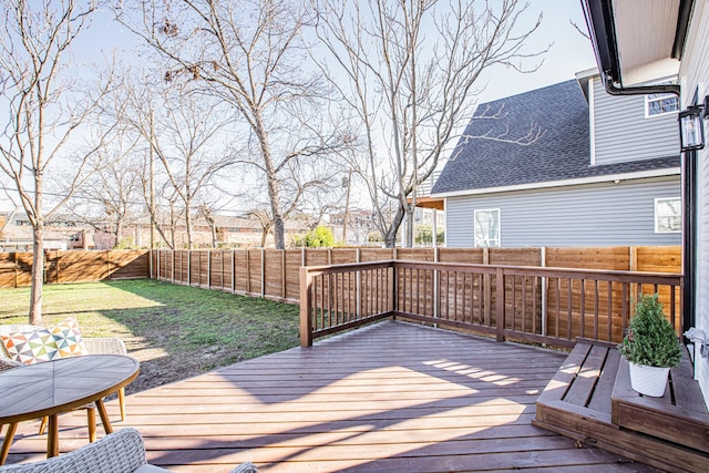 wooden deck featuring a yard