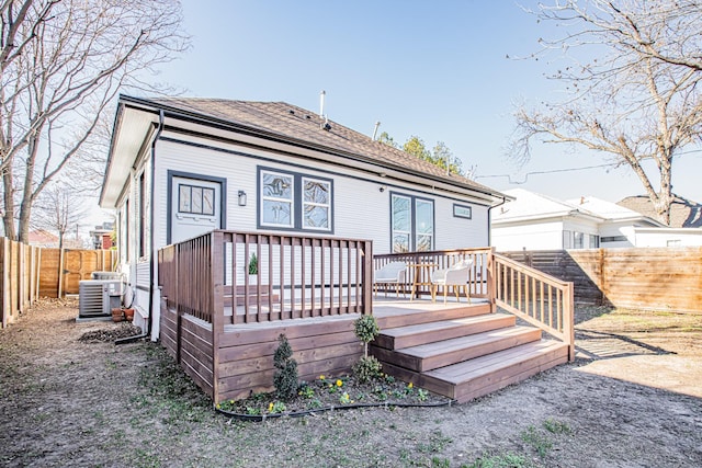 back of house with a wooden deck and central AC