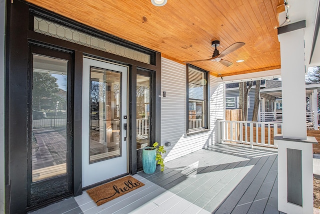 wooden terrace featuring ceiling fan and a porch