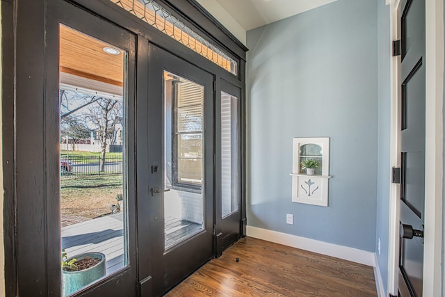 entryway with dark wood-type flooring and a healthy amount of sunlight