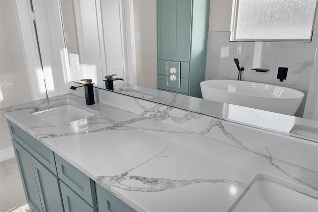 bathroom featuring vanity, a bathtub, and tile walls