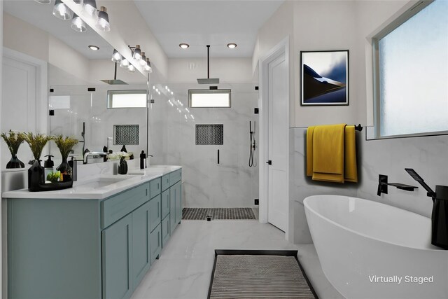 bathroom featuring vanity, separate shower and tub, and tile walls