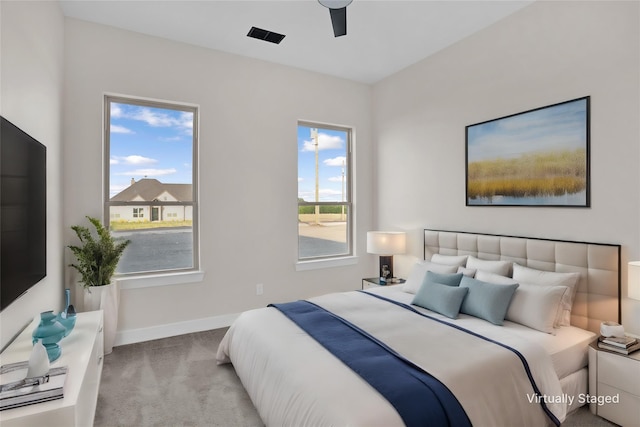 bedroom featuring ceiling fan and light carpet