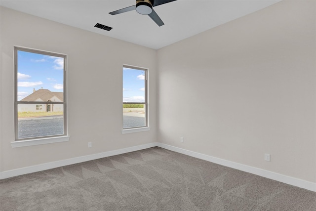 carpeted empty room featuring ceiling fan