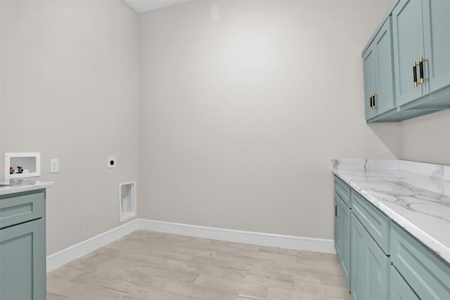 washroom with cabinets, hookup for a washing machine, light hardwood / wood-style floors, and electric dryer hookup