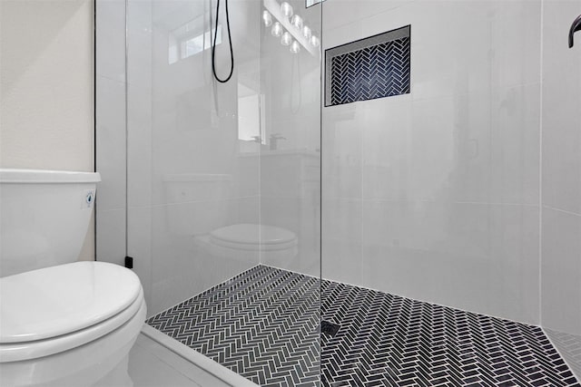 bathroom featuring a tile shower and tile patterned floors