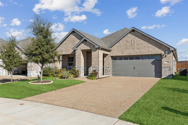 view of front of house featuring central AC, a garage, and a front lawn