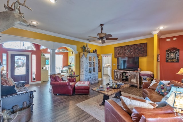 living room featuring hardwood / wood-style flooring, ornamental molding, ceiling fan, and ornate columns