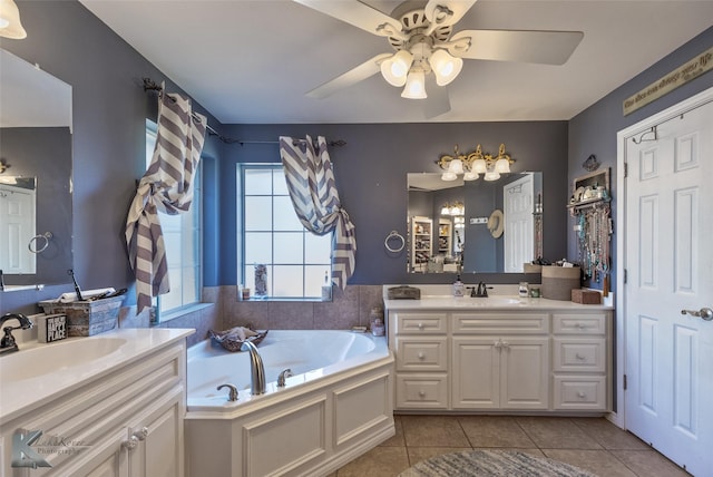 bathroom featuring ceiling fan, tile patterned floors, a bathtub, and vanity