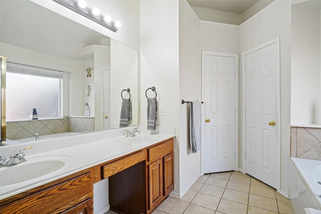 bathroom featuring tile patterned floors, vanity, a tub to relax in, and tasteful backsplash