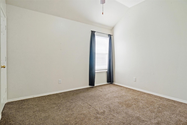 spare room with carpet, vaulted ceiling, and ceiling fan