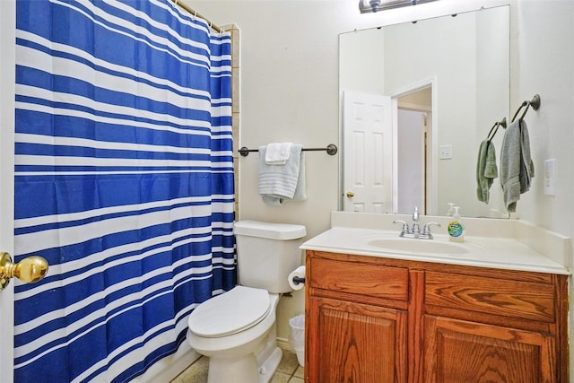 bathroom with tile patterned flooring, vanity, and toilet