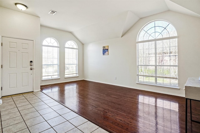 entrance foyer with lofted ceiling and light hardwood / wood-style floors