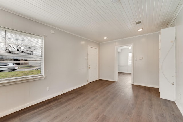 unfurnished room featuring hardwood / wood-style flooring, plenty of natural light, and ornamental molding