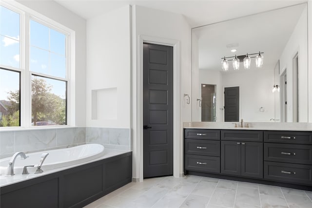 full bathroom featuring vanity and a bath