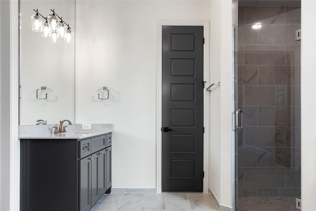 bathroom with a stall shower, marble finish floor, vanity, and baseboards