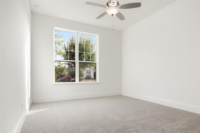 empty room with carpet floors, a wealth of natural light, baseboards, and a ceiling fan