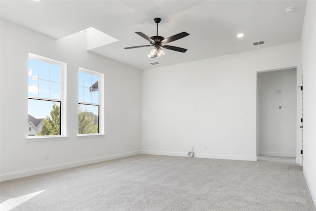 unfurnished room featuring recessed lighting, light carpet, visible vents, baseboards, and a ceiling fan