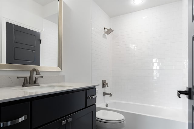 bathroom featuring toilet, washtub / shower combination, and vanity