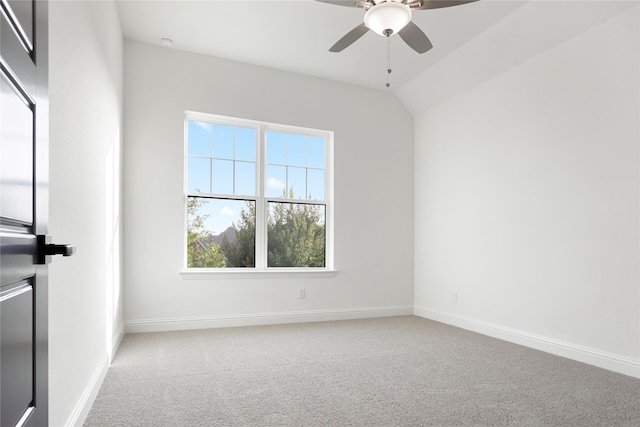 unfurnished room with carpet, vaulted ceiling, baseboards, and ceiling fan