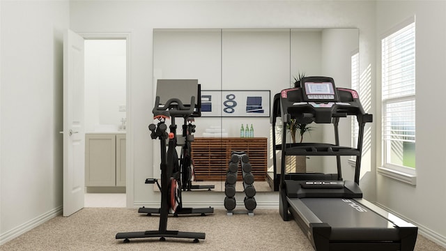 exercise room featuring light colored carpet