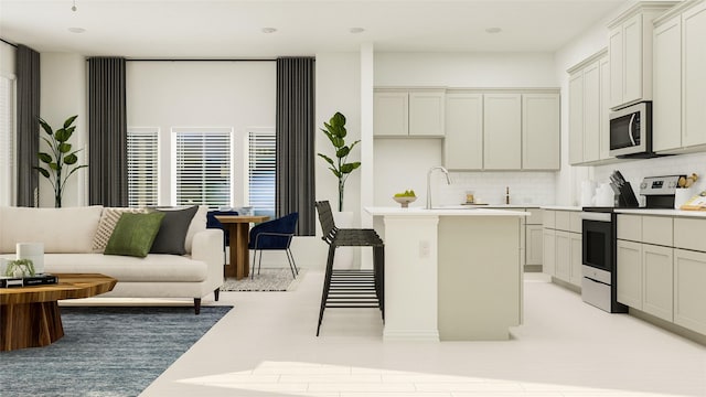 kitchen with appliances with stainless steel finishes, a breakfast bar area, a kitchen island, and backsplash