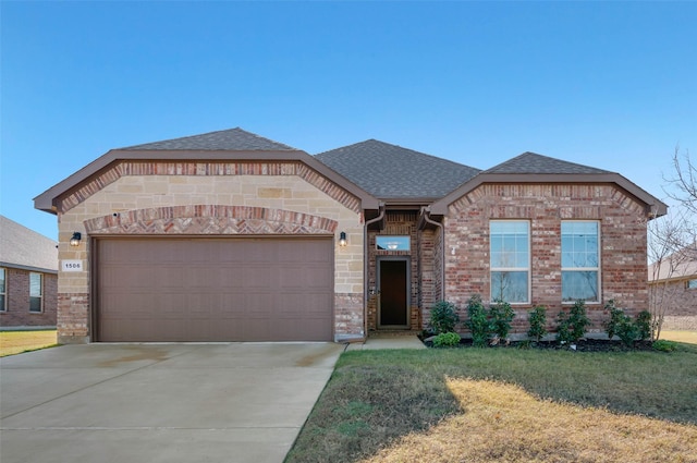 view of front of property with a garage and a front lawn