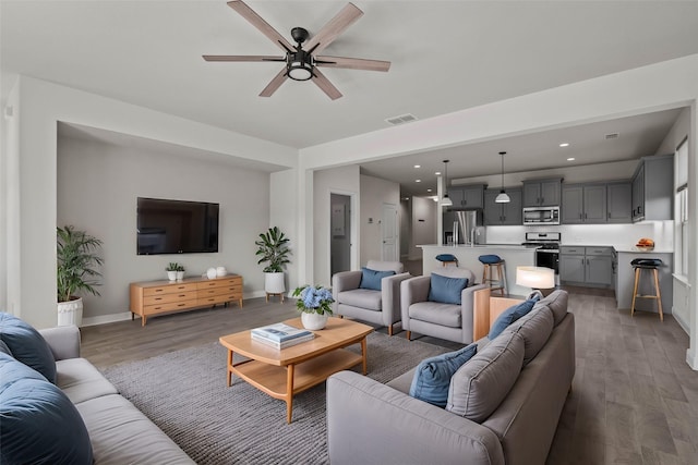 living room featuring dark hardwood / wood-style floors and ceiling fan