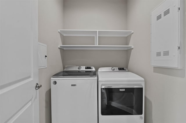 clothes washing area with washer and clothes dryer