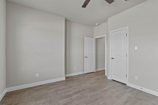 unfurnished room featuring ceiling fan and light hardwood / wood-style flooring