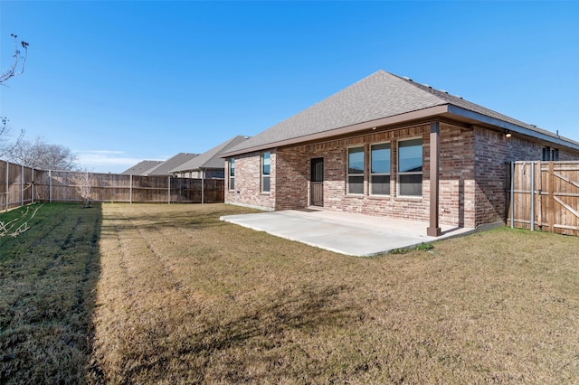 rear view of property featuring a yard and a patio