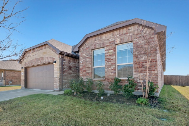 view of front of home with a garage and a front lawn