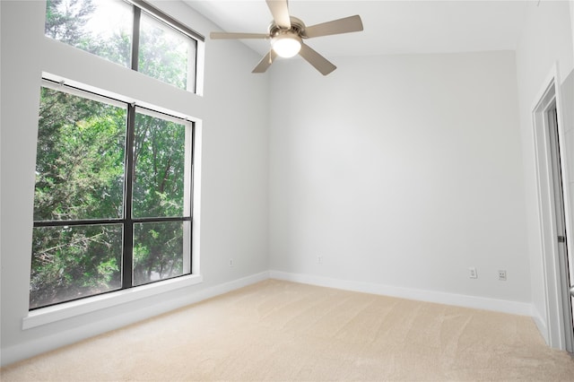 empty room with carpet flooring, ceiling fan, and lofted ceiling