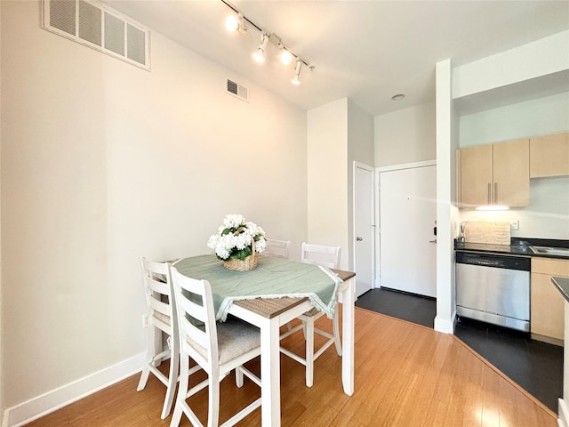 dining area featuring dark hardwood / wood-style floors and sink