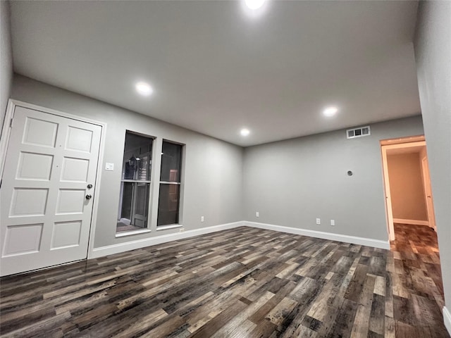 unfurnished room with dark hardwood / wood-style flooring