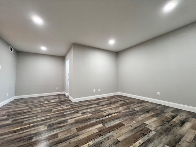 spare room with dark wood-type flooring