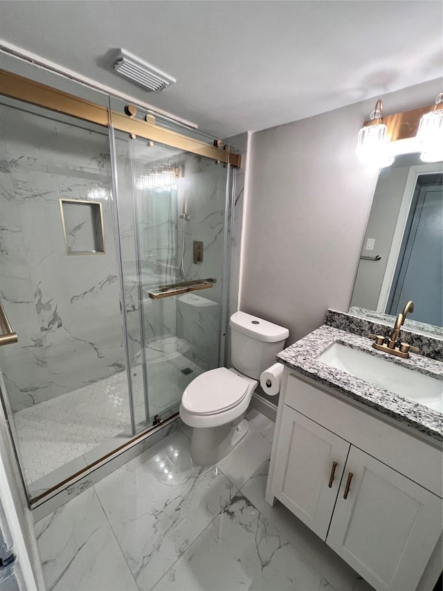 bathroom featuring toilet, vanity, and walk in shower